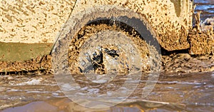 SUV wheel stalled in mud and water