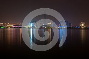 Suzhou city viewed from the lake with colorful lights reflecting in the water