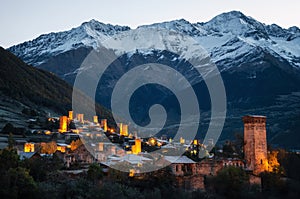 Svan towers with illumination in Mestia at sunrise, Svaneti, Georgia.