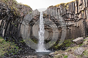 Svartifoss waterfall in Skaftafell National Park in Iceland, surrounded by dark basalt columns