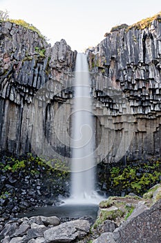 Svartifoss waterfall in Skaftafell National Park in Iceland, surrounded by dark basalt columns