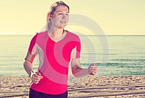 Svelte woman jogging on beach