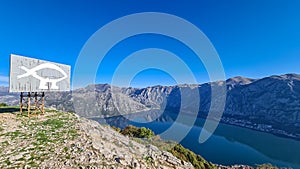 Sveti Ilija - Drawing of fish with legs on mountain peak Vrmac Sveti Ilija with panoramic view on Kotor bay, Montenegro