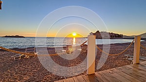 Sveti Stefan - Scenic sunset view from beach bar in Sveti Stefan, Adriatic Mediterranean Sea, Budva Riviera, Montenegro