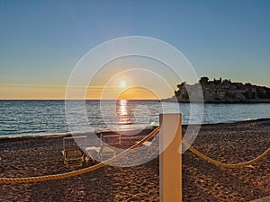 Sveti Stefan - Scenic sunset view from beach bar in Sveti Stefan, Adriatic Mediterranean Sea, Budva Riviera, Montenegro