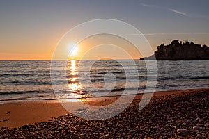 Sveti Stefan - Scenic sunset view from Sveti Stefan Beach at Adriatic Mediterranean Sea, Budva Riviera, Montenegro, Europe