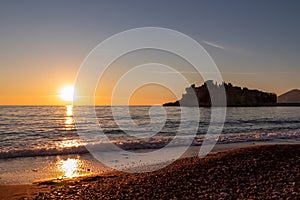 Sveti Stefan - Scenic sunset view from Sveti Stefan Beach at Adriatic Mediterranean Sea, Budva Riviera, Montenegro, Europe