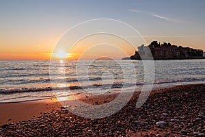 Sveti Stefan - Scenic sunset view from Sveti Stefan Beach at Adriatic Mediterranean Sea, Budva Riviera, Montenegro, Europe