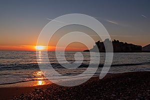 Sveti Stefan - Scenic sunset view from Sveti Stefan Beach at Adriatic Mediterranean Sea, Budva Riviera, Montenegro, Europe