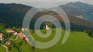 Sveti Tomaz, Slovenia - 4K aerial footage about drone flying away Saint Tomas Sveti Tomaz Church at Skofja Loka
