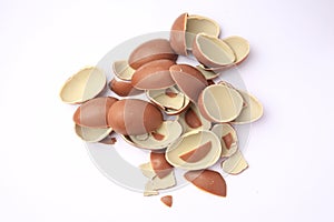 Sveti Vlas, Bulgaria - July 3, 2023: Broken halves of Kinder Surprise Eggs isolated on white, top view