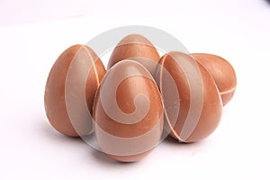 Sveti Vlas, Bulgaria - June 27, 2023: Unwrapped Kinder Surprise Eggs isolated on white