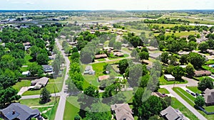 SW 4th street in Checotah, McIntosh County, Oklahoma with Interstate I-40 and water tower in background, row of single-family photo