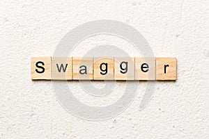 swagger word written on wood block. swagger text on table, concept photo