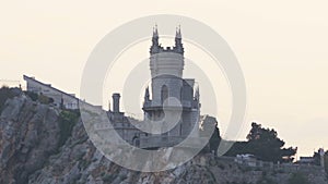 Swallow`s Nest castle on the rock over the Black Sea on the sunset. Gaspra. Crimea