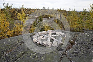 Swamp or lake with megalithic seid boulder stones, dead trees in nature reserve on mountain Vottovaara, Karelia, Russia. Shamanic