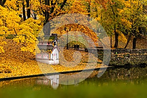 Swan House in Bastion Hill Park  Riga reflecting in canal water during beautiful autumn day surrounded with yellow leaved trees