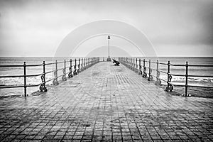 Swanage seaside town pier on a winters day. A black and white treatment