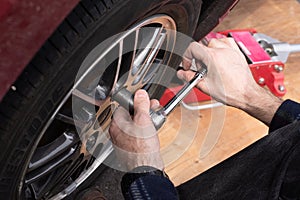 Swapping winter wheels and tires to summer on your car. Break bar and Car jack being used