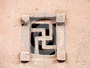 A swastika shaped window of Bete Maryam church in Lalibela, Ethiopia.