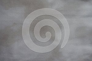 Swatch of viscose and polyester fabric with tie-dye pattern in shades of gray