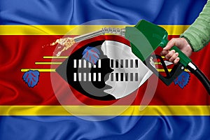 SWAZILAND flag Close-up shot on waving background texture with Fuel pump nozzle in hand. The concept of design solutions. 3d