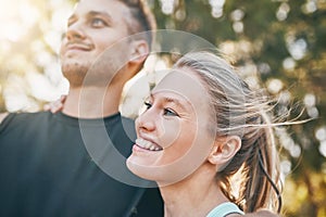 Sweat, smile and repeat. a young couple smiling together outdoors.