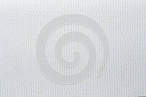 Sweater or scarf fabric texture large knitting. Knitted jersey background with a relief pattern. Wool hand- machine