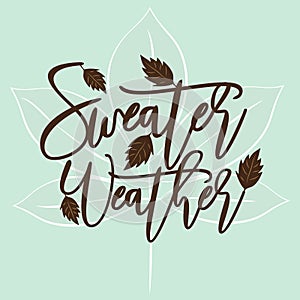 Sweater weather - autumnal thanksgiving handwritting text, with leaves, on mint color background.