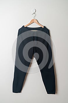 Sweatpants or jogger pants hanging on wall