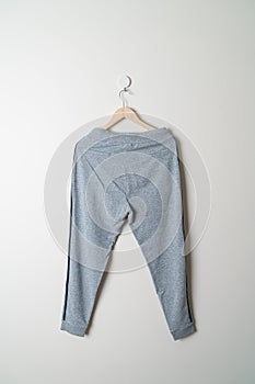 Sweatpants or jogger pants hanging on wall