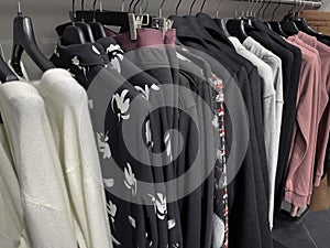 Sweatshirts and hoodies hanging on a rack