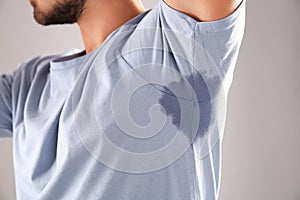 Sweaty man with stain on t-shirt