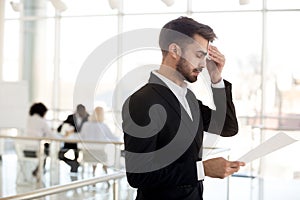 Sweaty nervous businessman wiping forehead afraid before public photo