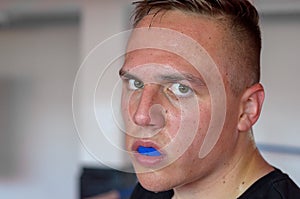 Sweaty young boxer wearing a mouthguard photo