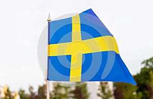 Sweden flag, city street background