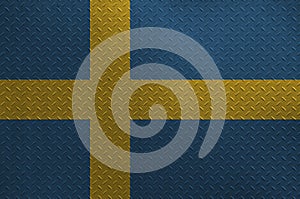Sweden flag depicted in paint colors on old brushed metal plate or wall closeup. Textured banner on rough background