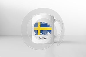 Sweden flag on white coffee mug.