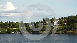 Sweden. Idyllic Stockholm archipelago style. Amazing Swedish Wooden Log Cabin House On Rocky Island. Traditional red