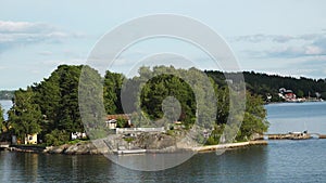 Sweden. Idyllic Stockholm archipelago style. Amazing Swedish Wooden Log Cabin House On Rocky Island. Traditional red