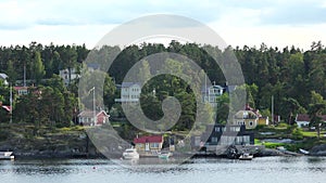 Sweden. Idyllic Stockholm archipelago style. Amazing Swedish Wooden Log Cabin House On Rocky Island. Traditional red