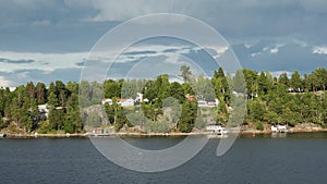 Sweden. Idyllic Stockholm archipelago style. Amazing Swedish Wooden Log Cabin House On Rocky Island. Traditional red