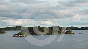 Sweden. Idyllic Stockholm archipelago style. Amazing Swedish Wooden Log Cabin House On Rocky Island. Traditional red