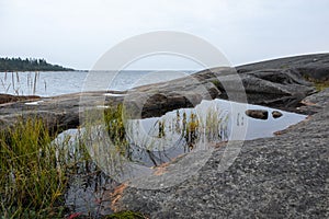 Sweden rocky sea side. Northern epic mystic cloudy grey landscape