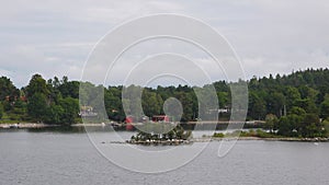 Sweden. Sail away in Stockholm Archipelago. Amazing Swedish Wooden Log Cabin House On Rocky Island. Beautiful homes and