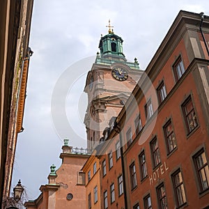 Sweden, Stockholm, on an old street in Gamlastan. The ancient part of the city. The bell tower of the church of St photo