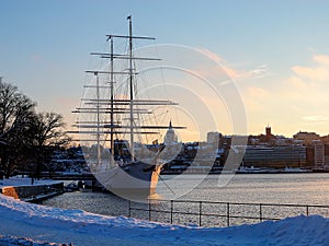 Sweden - winter Stockholm - sailing ship near quayside at sunset