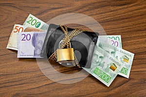 Swedish banknotes sticking out from a locked black wallet photo