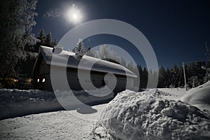 Swedish barn in clear winter night with bright moon