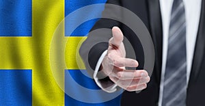 Swedish business, politics, cooperation and travel concept. Hand on flag of Sweden background